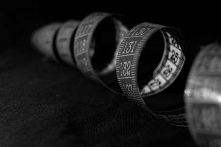 Black and white tailor's meter arranged in a spiralの写真素材
