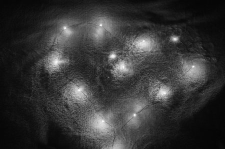A heart made of luminous copper wire in black and white on soft blanket