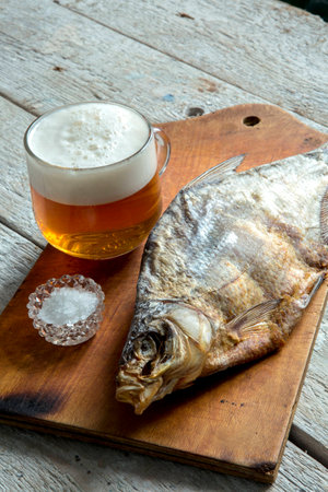 Dried dried fish, beer and breadの写真素材