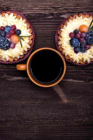 Black coffee, sweet berry pie, place for textの写真素材