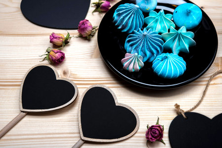 Blue meringue, black plate for text, dried flowersの写真素材