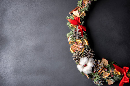 Christmas wreath of cones, lemons, cinnamon and berriesの写真素材