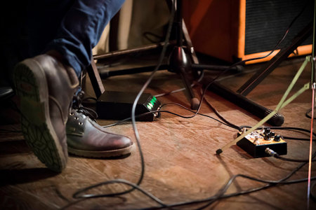 Feet of the musician on stage, guitar processor, columnの写真素材