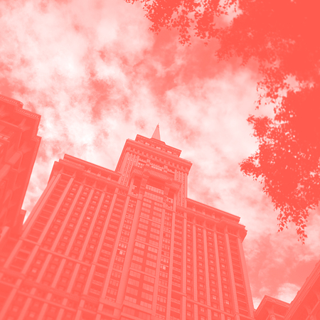 Bottom view of a skyscraper in Moscow, Russia, sky and clouds, tinted duotone in the color of the year Panton 2019 live coralの写真素材