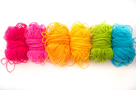 multicolored threads lie on a white background top view