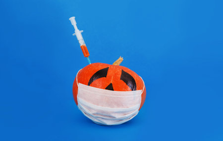 a sick pumpkin in a mask is vaccinated against covid19.