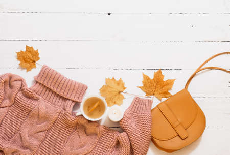 sweater, maple leaves, hot tea, autumn still life on a white background.の写真素材