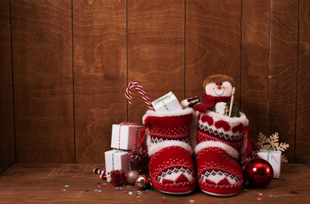 Little knitted boots with Christmas gifts and various decorations.