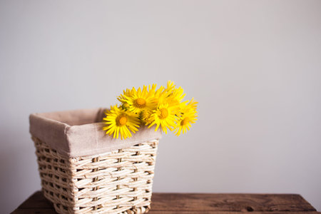 bouquet of yellow flowers daisies in a basket.