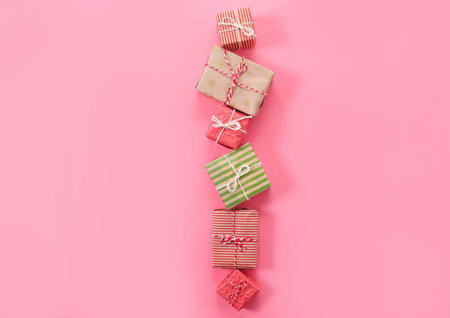 lots of Christmas gifts on pink background.
