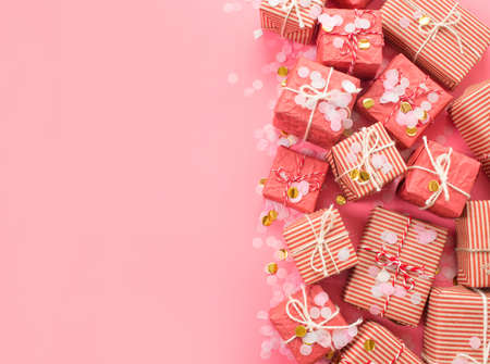 lots of Christmas gifts on pink background.の写真素材