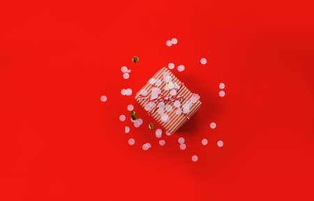 Christmas gifts Gifts on a red background. Simple, classic red and white packaged gift boxes with ribbon bows and holiday decorations.の写真素材