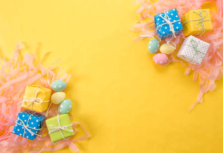 lots of Christmas gifts on yellow background.の写真素材