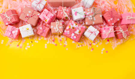 lots of Christmas gifts on yellow background.の写真素材