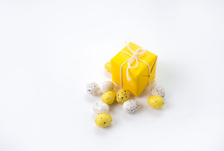 Easter composition of boxes and colorful eggs on a light background.