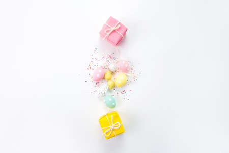 Easter composition of boxes and colorful eggs on a light background.の写真素材