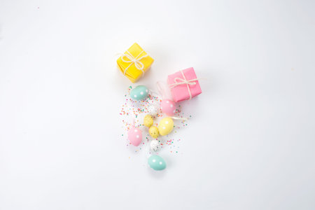 Easter composition of boxes and colorful eggs on a light background.