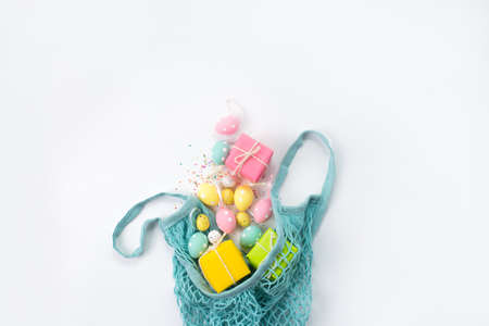 bag with sprinkled Easter eggs on a white background. Background for easter.の写真素材