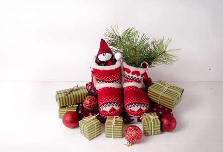 Little knitted boots with Christmas gifts and various decorations.の写真素材