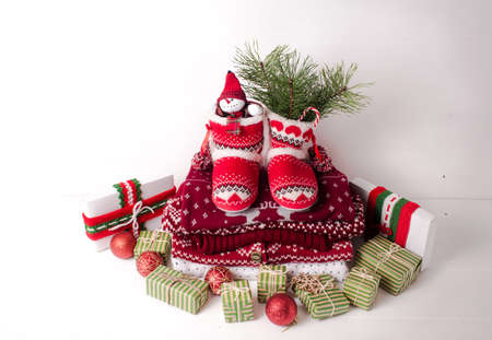 Little knitted boots with Christmas gifts and various decorations.の写真素材
