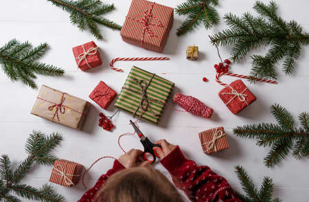 the child is preparing for the new year. Needlework Christmas gifts in colorful boxesの写真素材