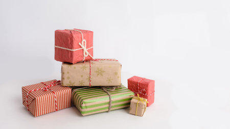 Lots of Christmas gifts in large and small boxes, on a white isolated background