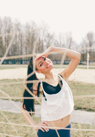 young athletic girl doing exercise warm up at the stadium.の写真素材