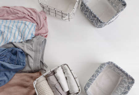 Many colorful clothes are lying on the floor. baskets for folding clothes. The view from the top.の写真素材