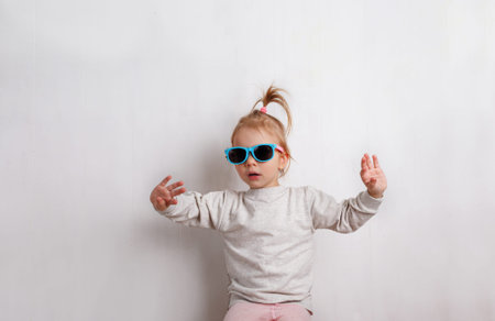 little girl with sunglasses on a white backgroundの写真素材