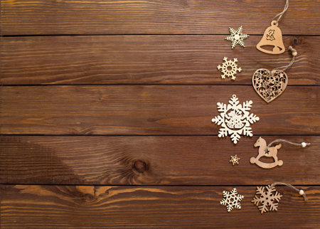 lots of wooden toys for Christmas tree on wooden background top view.の写真素材