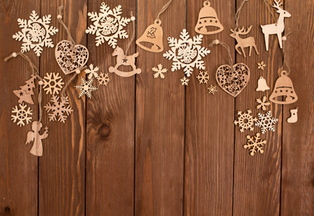 lots of wooden toys for Christmas tree on wooden background top view.の写真素材