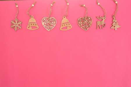 a lot of wooden toys for Christmas tree isolated on pink background view from above.の写真素材