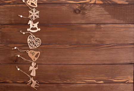 lots of wooden toys for Christmas tree on wooden background top view.の写真素材