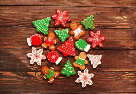 colorful ginger cookies in a bright glaze are laid out on a wooden background.Ginger men. Christmas cookies. The view from the top.の写真素材