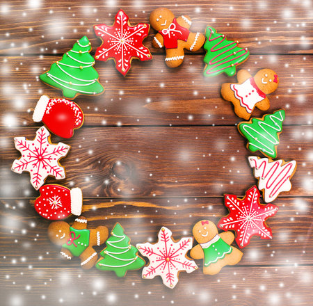 colorful ginger cookies in a bright glaze are laid out on a wooden background.Ginger men. Christmas cookies. The view from the top.の写真素材