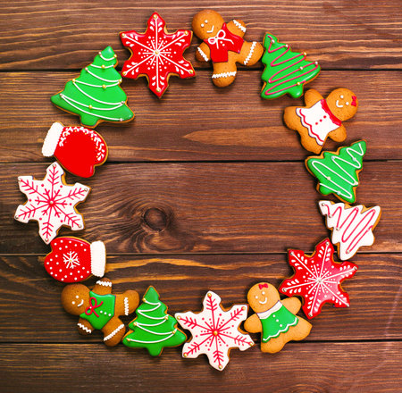 colorful ginger cookies in a bright glaze are laid out on a wooden background.Ginger men. Christmas cookies. The view from the top.の写真素材