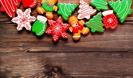 colorful ginger cookies in a bright glaze are laid out on a wooden background.Ginger men. Christmas cookies. The view from the top.の写真素材