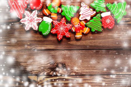 colorful ginger cookies in a bright glaze are laid out on a wooden background.Ginger men. Christmas cookies. The view from the top.の写真素材
