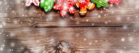 colorful ginger cookies in a bright glaze are laid out on a wooden background.Ginger men. Christmas cookies. The view from the top.の写真素材