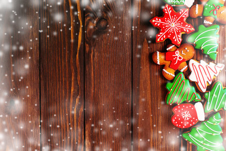 colorful ginger cookies in a bright glaze are laid out on a wooden background.Ginger men. Christmas cookies. The view from the top.の写真素材