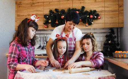 Grandma Teaches Her children and grandchildren to cook cookies according to an Old recipe.の写真素材