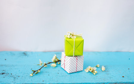 gift boxes of white and light green color on a blue spring background. Spring composition.の写真素材