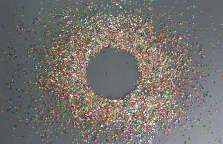 multicolored confetti on a gray background circle inside.の写真素材