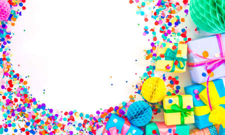 lots of colorful gift boxes and colorful confetti on a white background. Top viewの写真素材
