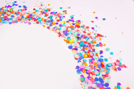 multicolored small confetti on a white background. Top view.の写真素材