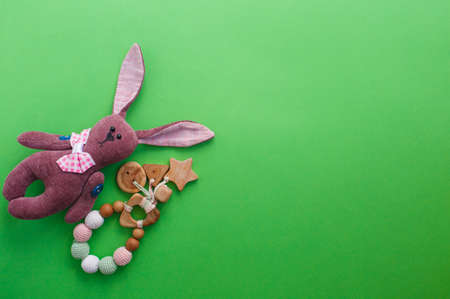 Beautiful children's toys are laid out on a green background top view. space for textの写真素材