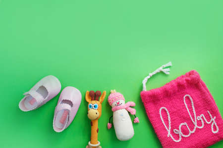 children's shoes lie on a light green background top view. space for the text. baby slippers.の写真素材