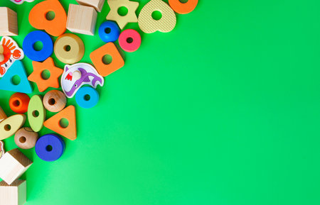 Beautiful children's toys are laid out on a green background top view. space for textの写真素材