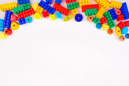 multi-colored children's toy constructors on a white background top view. Space for text