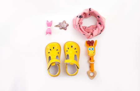 children's clothing and shoes are laid out on a white background top view. Space for the text.の写真素材